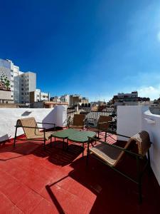 a patio with a table and chairs on a roof at Terrazas de la Catedral III in Castellón de la Plana