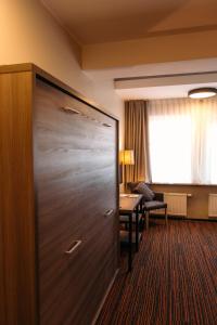 a large door in a hotel room with a desk at Braavo Spa Hotel in Tallinn