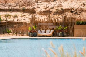 a couch sitting next to a swimming pool at Hotel Dakhla Club & SPA in Dakhla