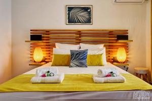 a bedroom with a bed with two towels on it at TIGOUYA - House of 135m - 2 bedrooms Jacuzzi in Stella Matutina +14 photos