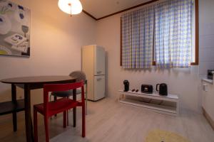 a small kitchen with a table and a refrigerator at 퍼즈스테이 Pause Stay in Chuncheon +27 photos