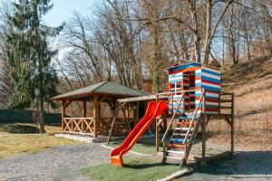 a playground with a slide and a gazebo at Sovata Apartment in Sovata