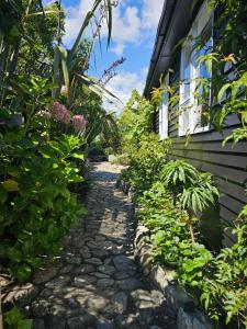a garden path in front of a house at Livingstone Retreat in Hokitika