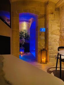 a room with a fireplace and a blue light at Victory Suite in Monopoli