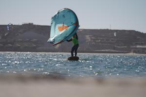 a man standing on a rock in the water with a sail at Hotel Dakhla Club & SPA in Dakhla +136 photos