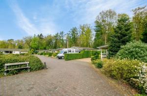 a driveway with a van parked in a park at De Bosparel in Doldersum +3 photos