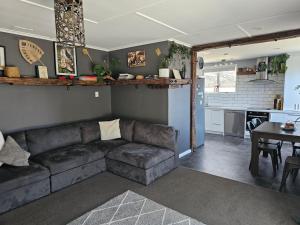 a living room with a couch and a table at Livingstone Retreat in Hokitika +47 photos