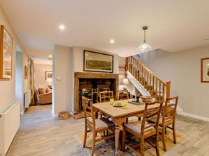 a dining room with a table and chairs and a fireplace at 3 Bed in Lockerbie oc-89759 in Ecclefechan +13 photos
