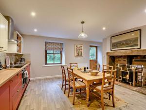a kitchen and dining room with a table and chairs at 3 Bed in Lockerbie oc-89759 in Ecclefechan
