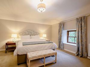 a bedroom with a large bed and a window at 3 Bed in Lockerbie oc-89759 in Ecclefechan