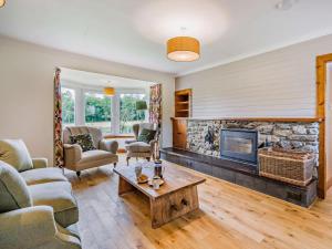 a living room with a stone fireplace and a table at 5 Bed in Dunkeld oc-90585 in Dunkeld +18 photos