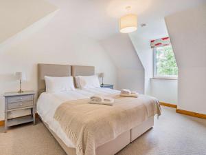 a bedroom with a bed with two towels on it at 5 Bed in Dunkeld oc-90585 in Dunkeld