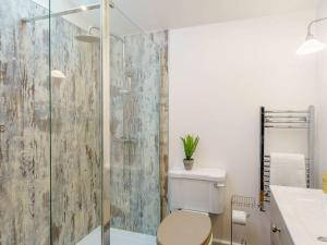 a bathroom with a toilet and a glass shower at 3 Bed in Colne oc-89582 in Colne +17 photos