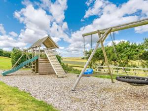 a playground with a slide and a play structure at 3 Bed in St. Andrews oc-88545 in Balmullo