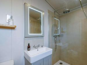 a white bathroom with a sink and a shower at 3 Bed in St. Andrews oc-88545 in Balmullo +18 photos
