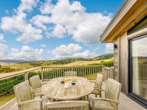 a patio with a table and chairs on a balcony at 3 Bed in St. Andrews oc-88545 in Balmullo