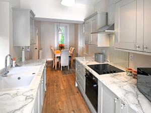a kitchen with marble counter tops and a dining room at 3 Bed in Lockerbie oc-95861 in Brydekirk