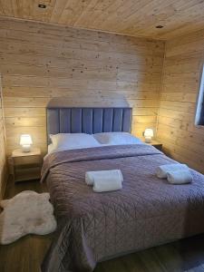 a bedroom with a bed with two towels on it at Poleska Przystań in Urszulin