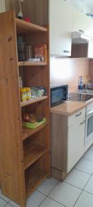 a kitchen with wooden shelves and a counter top at Ela Gar 2 WG Zimmer in Garsten