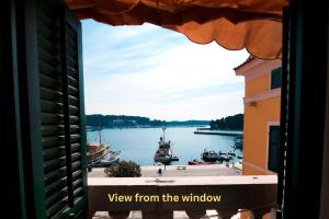 a view from a window of a harbor with boats in the water at Apartment Al Porto in Rovinj +15 photos