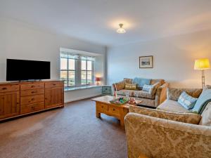 a living room with two couches and a flat screen tv at 2 Bed in Biggar oc-95516 in Biggar