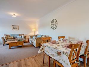 a living room with a table and a couch at 2 Bed in Biggar oc-95516 in Biggar