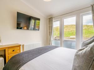 a bedroom with a bed and two windows at 2 Bed in Newton Stewart oc-79129 in Gillespie