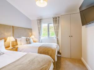 a bedroom with two beds and a window at 2 Bed in Newton Stewart oc-79129 in Gillespie