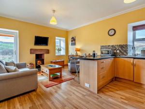a kitchen and living room with a couch and a table at 1 Bed in Edzell oc-ca335 in Edzell