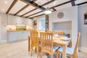a kitchen and dining room with a wooden table and chairs at 3 Bed in Catterick oc-ds934 in Catterick Bridge +6 photos
