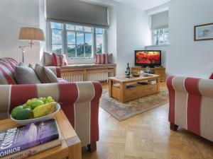 a living room with two couches and a television at 1 Bed in Spark Bridge oc-lcc52 in Spark Bridge