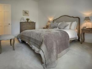 a bedroom with a large bed and a dresser at 1 Bed in Spark Bridge oc-lcc52 in Spark Bridge