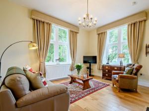 a living room with a couch and a table at 2 Bed in Langholm oc-83344 in Langholm
