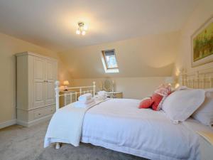 a bedroom with a white bed with pillows at 2 Bed in Langholm oc-83344 in Langholm