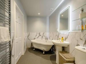 a bathroom with a white tub and a sink at 2 Bed in Sanquhar oc-89403 in Sanquhar +10 photos