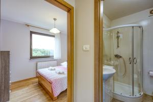 a bathroom with a bed and a shower and a sink at Apartma pri Cesarjevih in Sežana +39 photos