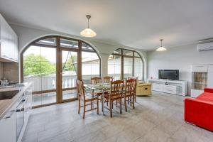 a kitchen and dining room with a table and chairs at Apartma pri Cesarjevih in Sežana