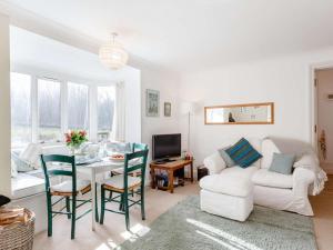 a living room with a table and a white couch at 3 Bed in Turriff oc-75489 in Turriff