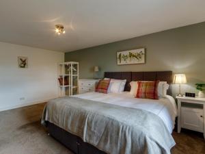 a bedroom with a large bed in a room at 3 Bed in Crieff oc-78313 in Madderty