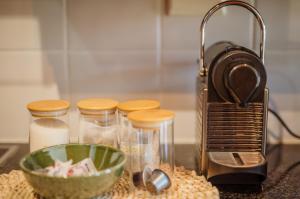 a kitchen counter with a toaster and a bowl of food at Central Stellenbosch Apartment with secure parking in Stellenbosch
