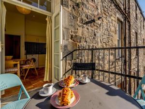 a table with two plates of food on a balcony at 3 Bed in Edinburgh oc-79008 in Edinburgh
