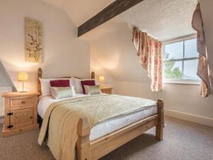 a bedroom with a large bed and a window at 6 Bed in Keswick oc-sz044 in Braithwaite