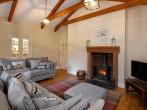 a living room with couches and a fireplace at 3 Bed in Annan oc-75355 in Annan
