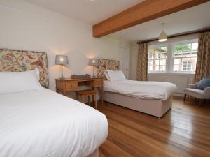 a bedroom with two beds and a desk and a window at 3 Bed in Annan oc-75355 in Annan +13 photos