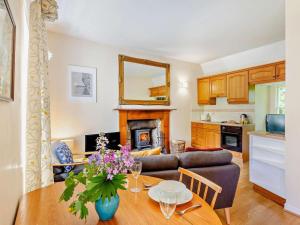a living room with a table and a couch at 1 Bed in Nethy Bridge oc-28823 in Nethy Bridge +7 photos