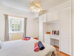a bedroom with a bed with two pillows on it at 1 Bed in Nethy Bridge oc-28823 in Nethy Bridge