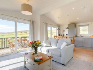 a living room with a couch and a table at 2 Bed in Isle Of Skye oc-87578 in Portree