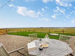 a wooden table with a plate of food on it at 3 Bed in Arbroath oc-90784 in Inverkeilor
