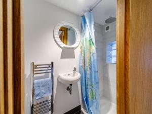 a small bathroom with a sink and a mirror at 3 Bed in Wigton oc-86087 in Caldbeck +21 photos