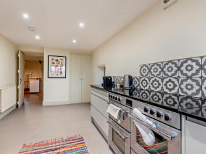 a kitchen with a stove and a counter top at 3 Bed in Penrith oc-93379 in Orton +17 photos